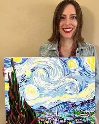 Customer holding completed custom paint by numbers portrait