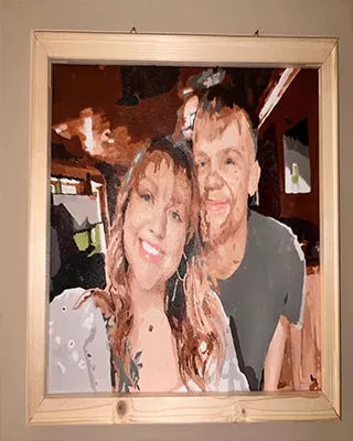 A favorite moment turned into a framed custom paint by numbers portrait of a smiling couple