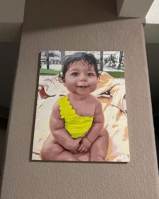 A precious baby portrait displayed as personalized paint by numbers wall art