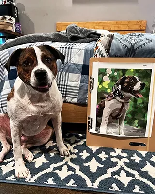 Beloved dog posing beside its custom paint by numbers portrait on an easel