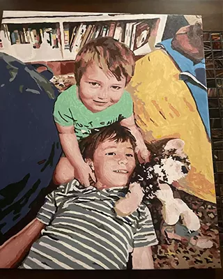 Brothers sharing a special moment with their kitten in a custom portrait