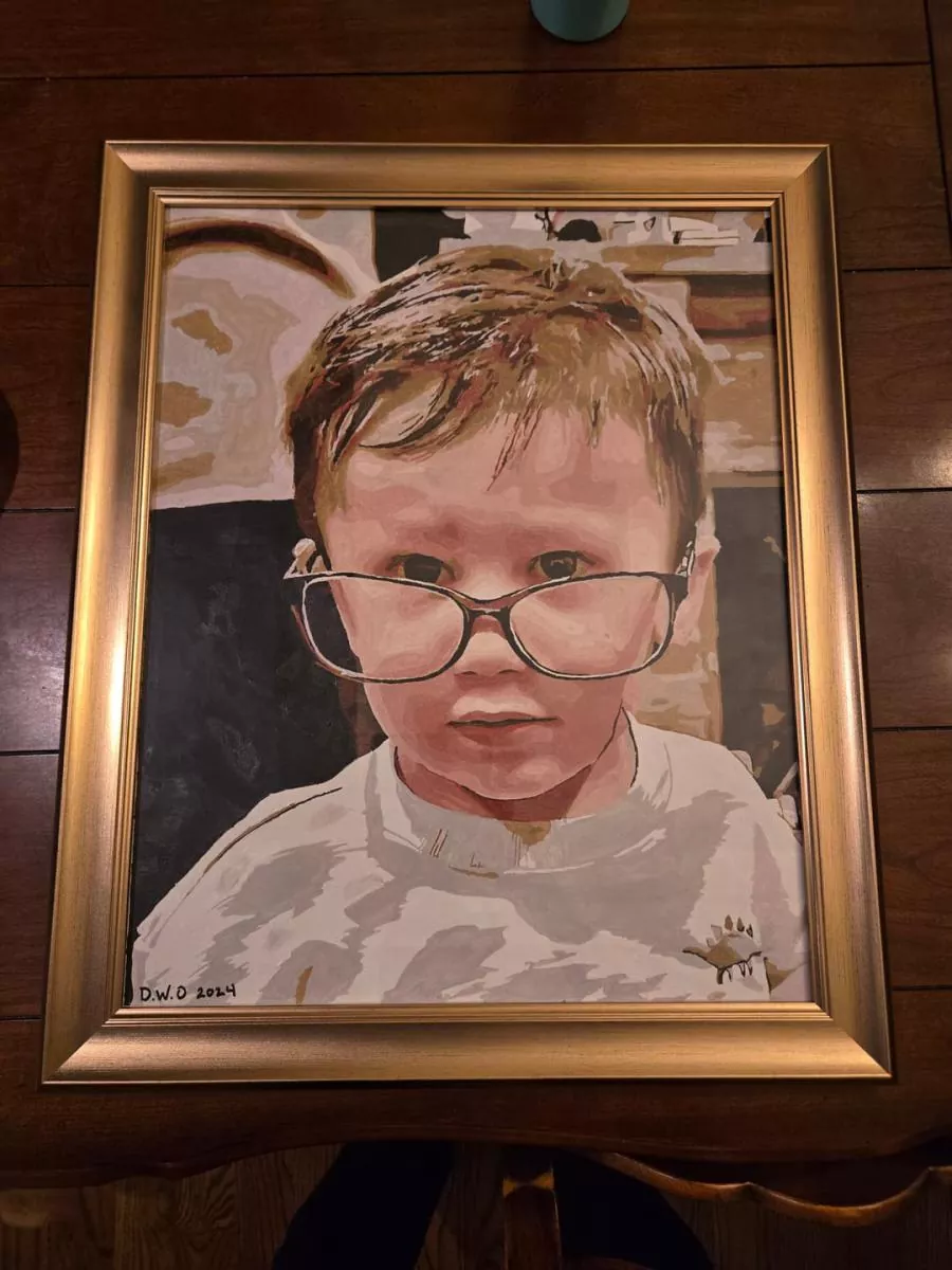 Custom paint by numbers portrait of a young child wearing oversized glasses in a gold frame