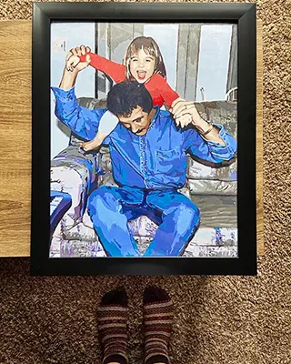 Framed custom paint by numbers of a joyful child playing on an adult's shoulders indoors