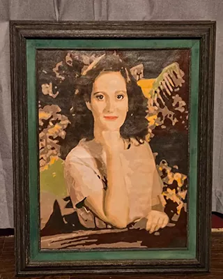 Framed custom portrait paint by numbers of a woman resting her chin on her hand