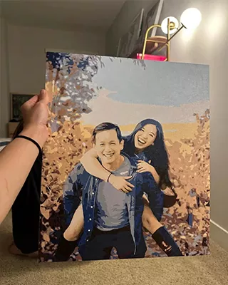Joyful couple captured in a custom paint by numbers portrait during a piggyback ride outdoors