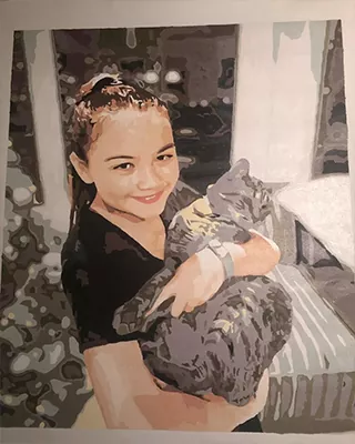 Young woman cuddling her cat in a custom paint by numbers portrait created from a favorite photo