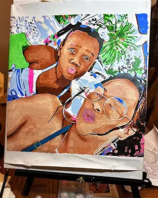 Adult and child making playful faces together in a custom paint by numbers portrait