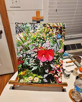 Bright red flower surrounded by lush greenery in a custom paint by numbers artwork