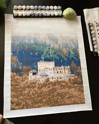 Castle surrounded by a colorful mountain landscape in a custom paint by numbers artwork