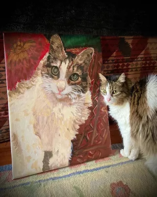 Cat posing beside its custom paint by numbers portrait