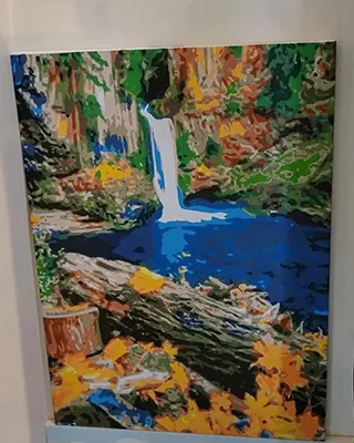 Colorful waterfall flowing into a blue forest pool in a custom paint by numbers landscape