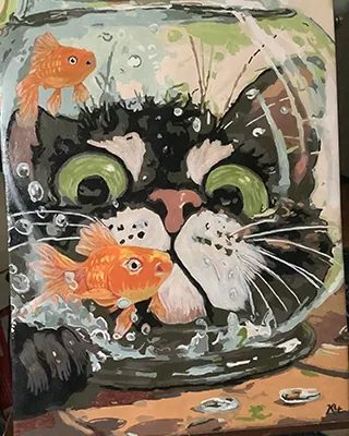 Curious black cat peering through a fishbowl with bright goldfish