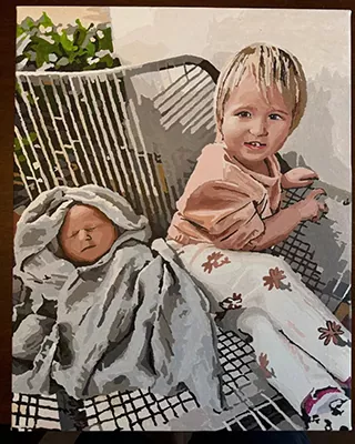 Custom family portrait of a young child sitting beside a sleeping newborn