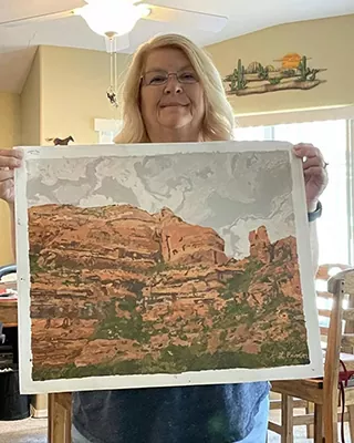 Custom landscape painting of red sandstone cliffs beneath a cloudy sky