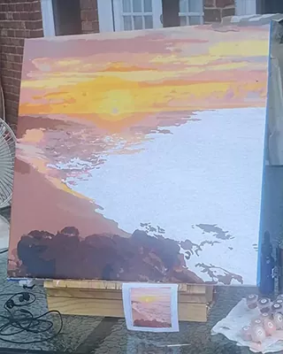 Custom paint by numbers landscape featuring a glowing sunset over a calm coastline