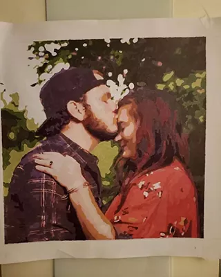 Custom paint by numbers portrait of a couple sharing a kiss outdoors