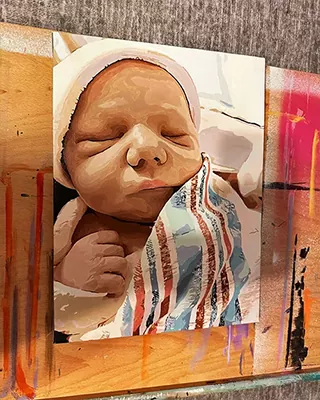 Custom paint by numbers portrait of a sleeping newborn baby wrapped in a striped blanket