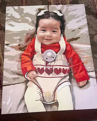 Custom paint by numbers portrait of a smiling baby in a red outfit