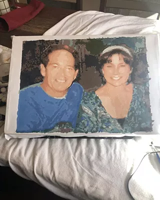 Custom paint by numbers portrait of a smiling couple recreated from a cherished photo