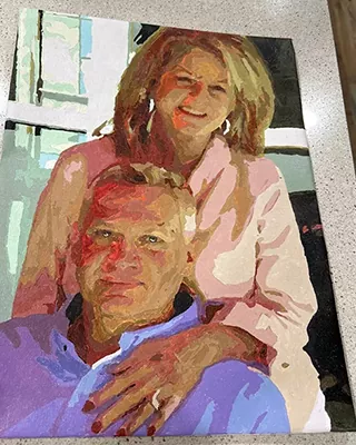 Custom paint by numbers portrait of a smiling couple recreated from a treasured photo