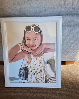 Custom paint by numbers portrait of a smiling young girl in a white frame