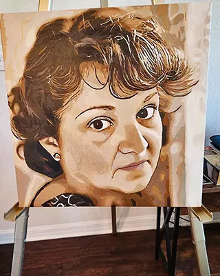 Custom paint by numbers portrait of a woman displayed on an easel