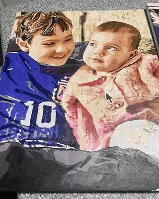 Custom paint by numbers portrait of siblings sharing a sweet moment together