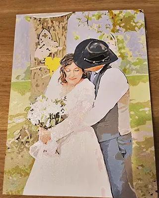 Custom paint by numbers wedding portrait of a bride and groom embracing beneath a tree