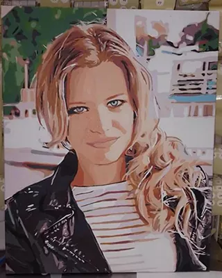 Finished paint by numbers canvas featuring a stylish blonde woman outdoors.