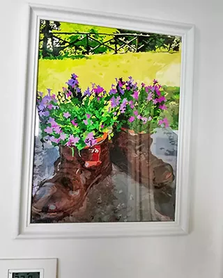 Framed custom paint by numbers of flower filled boots in a sunny garden