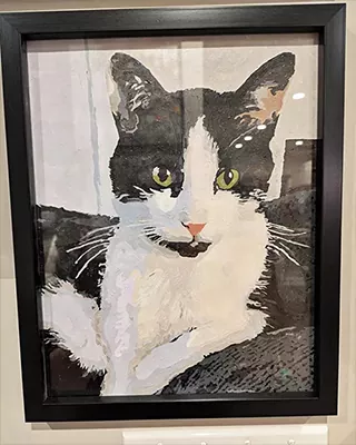 Framed custom paint by numbers portrait of a black and white cat with green eyes