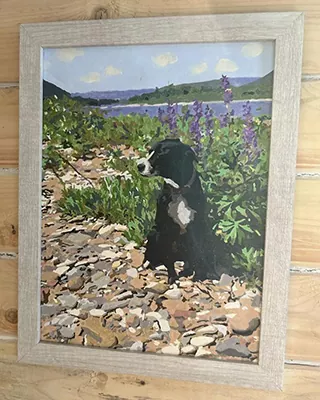 Framed custom paint by numbers portrait of a black dog among purple wildflowers