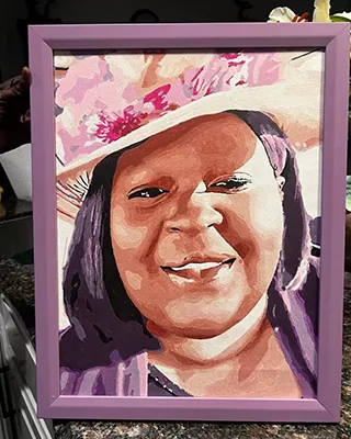 Framed custom paint by numbers portrait of a smiling woman in a hat