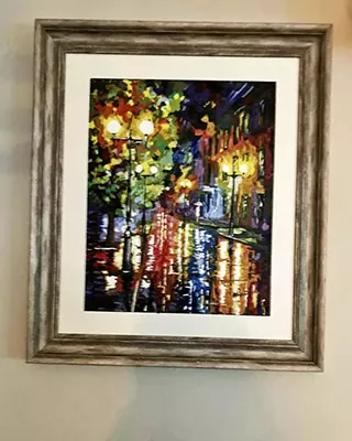 Framed rainy city street glowing with colorful lights in a custom paint by numbers artwork