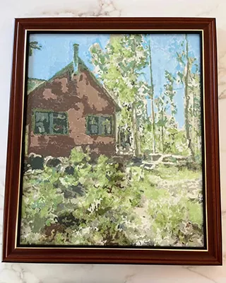 Framed woodland cottage surrounded by trees in a custom paint by numbers landscape