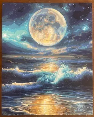 Moonlit ocean waves beneath a glowing full moon