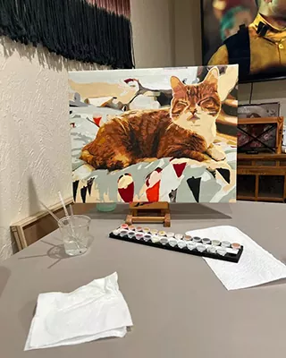 Orange tabby cat relaxing in a finished custom paint by numbers portrait