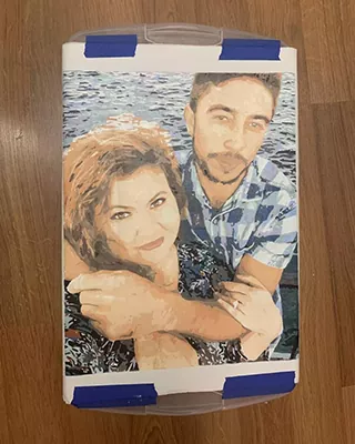 Personalized paint by numbers portrait of a smiling couple posing together by the water