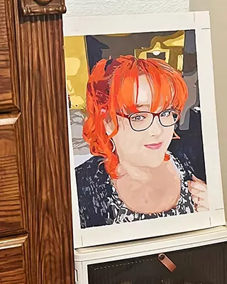Red-haired woman with glasses featured in a custom paint by numbers portrait