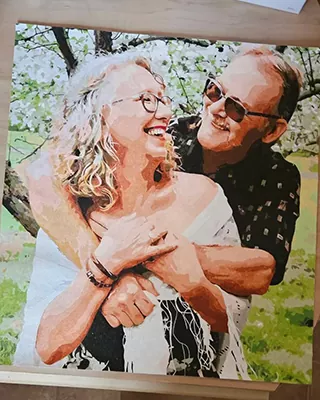 Smiling couple embracing outdoors in a custom paint by numbers portrait