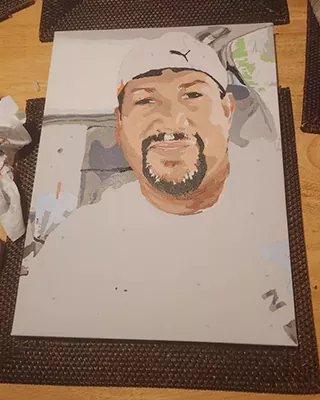 Smiling man wearing a white cap featured in a custom paint by numbers portrait