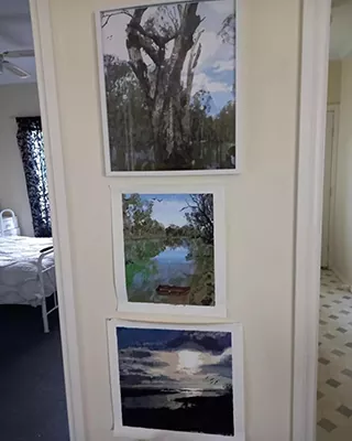 Three custom paint by numbers landscapes displayed vertically on a wall