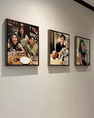 Three framed custom paint by numbers portraits displayed together on a wall