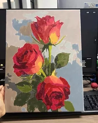 Three vibrant red roses with green leaves against a soft blue gray background