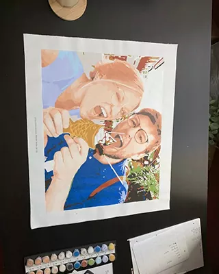 Two people sharing a cheerful moment in a custom paint by numbers portrait