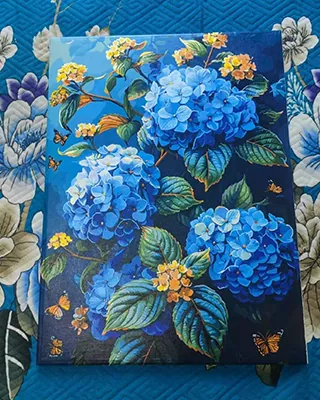 Vibrant blue hydrangeas surrounded by golden butterflies and lush green leaves