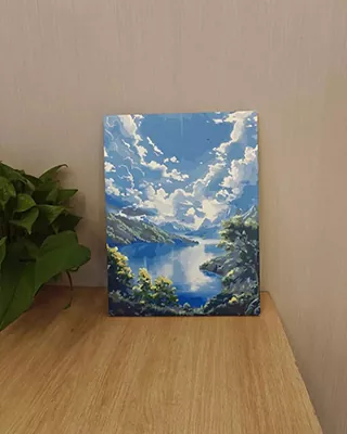 Vibrant custom landscape paint by numbers of a crystal blue lake surrounded by mountains beneath dramatic sunlit clouds